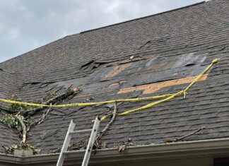 Missing Shingles on Roof: Will It Leak, Can You Replace Them, or Is It Time for a New Roof? A roof with several missing asphalt shingles after wind damage exposing the underlayment