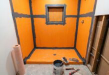 Waterproof Membrane for Shower: What Goes Behind Tile and Why It Matters A waterproof membrane for shower walls and floor being installed before tile in a bathroom remodel