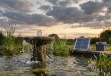 Best Solar Water Fountain Pump With Battery Backup (2026 Picks) Solar water fountain pump with battery backup running at dusk in a backyard bird bath