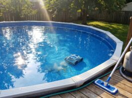 Best Above Ground Pool Vacuum: Robotic, Battery & Manual Picks Above ground pool vacuum cleaning a vinyl liner pool with a robotic pool cleaner and manual vacuum nearby