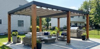 Freestanding Pergola: Kits, Placement, Anchoring & Buying Guide Modern freestanding pergola on a backyard patio with outdoor furniture, shade canopy, and anchored posts