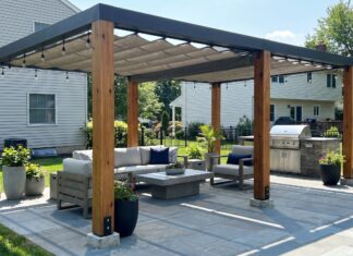 Freestanding Pergola: Kits, Placement, Anchoring & Buying Guide Modern freestanding pergola on a backyard patio with outdoor furniture, shade canopy, and anchored posts