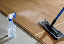 How to Clean Engineered Hardwood Floors Without Damage Microfiber mop cleaning engineered hardwood flooring with a light spray cleaner and no standing water