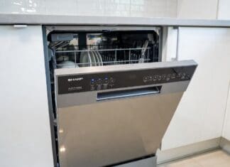 Sharp Dishwasher Reviews: Best Models, Pros, Cons & Value Picks Stainless steel Sharp dishwasher installed in a modern kitchen with clean dishes and silverware racks