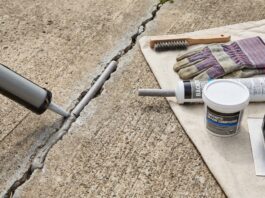 Best Concrete Crack Filler for Driveways, Patios & Large Cracks Concrete crack filler applied to a driveway crack with repair tools nearby
