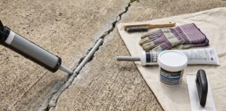 Best Concrete Crack Filler for Driveways, Patios & Large Cracks Concrete crack filler applied to a driveway crack with repair tools nearby