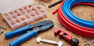 PEX Crimp Tool: Best Kits, Sizes, How to Use & Buying Tips PEX crimp tool kit with copper crimp rings, cutter, gauge, and PEX pipe on a workbench