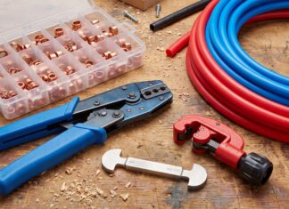 PEX Crimp Tool: Best Kits, Sizes, How to Use & Buying Tips PEX crimp tool kit with copper crimp rings, cutter, gauge, and PEX pipe on a workbench
