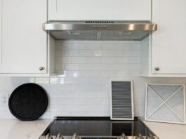 Range Hood Charcoal Filters: How Often to Replace Them & What to Buy Range hood charcoal filters and metal grease filter on a kitchen counter below a ductless hood