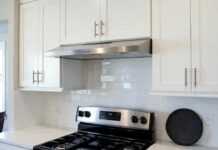Under Cabinet Ductless Range Hood: Buying Tips, Filters & Installation Under cabinet ductless range hood installed above a stove in a modern apartment kitchen
