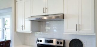 Under Cabinet Ductless Range Hood: Buying Tips, Filters & Installation Under cabinet ductless range hood installed above a stove in a modern apartment kitchen