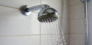 What Makes a Shower Head High Pressure? Spray Force, GPM & Nozzles Chrome shower head spraying focused water streams in a modern bathroom
