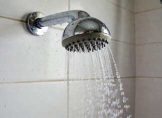 What Makes a Shower Head High Pressure? Spray Force, GPM & Nozzles Chrome shower head spraying focused water streams in a modern bathroom