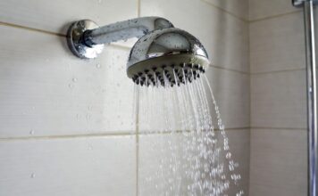 What Makes a Shower Head High Pressure? Spray Force, GPM & Nozzles Chrome shower head spraying focused water streams in a modern bathroom