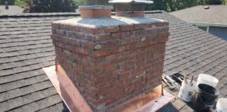Chimney Repair: Costs, Warning Signs, Flashing, Crown & Brick Fixes Chimney repair showing damaged brick, flashing, crown, and masonry above a residential roof