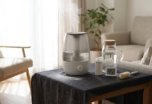 Ultrasonic Humidifier White Dust: Why It Happens, How to Stop It & When to Switch Ultrasonic humidifier white dust on a table with distilled water, demineralization cartridge, hygrometer, and cleaning brush
